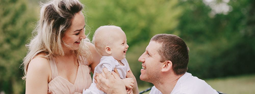 a man and a woman eating a piece of grass